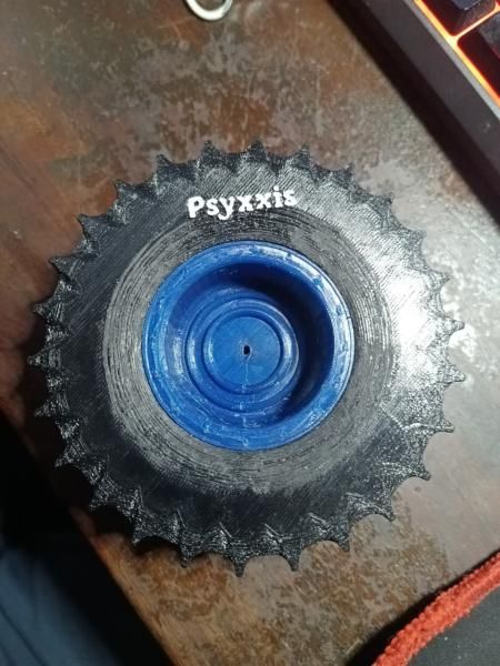 A black TPU tyre with deep treads on a blue rim