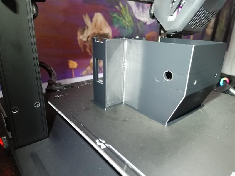 The grey body shell printing on the 3D printer's bed